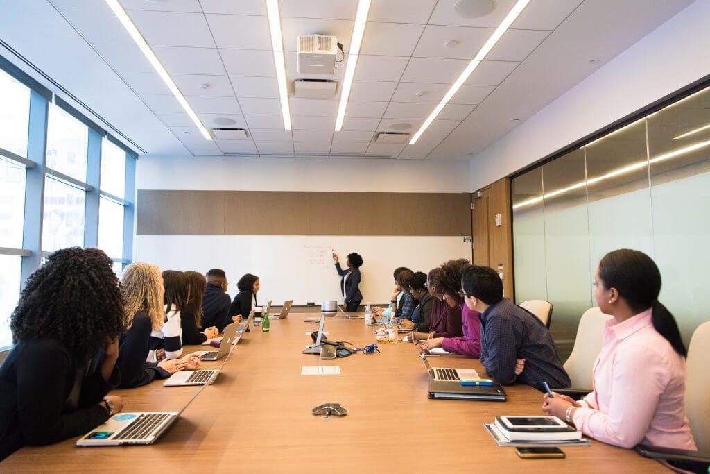 Conducting an employee training session in a training room with a large number of people