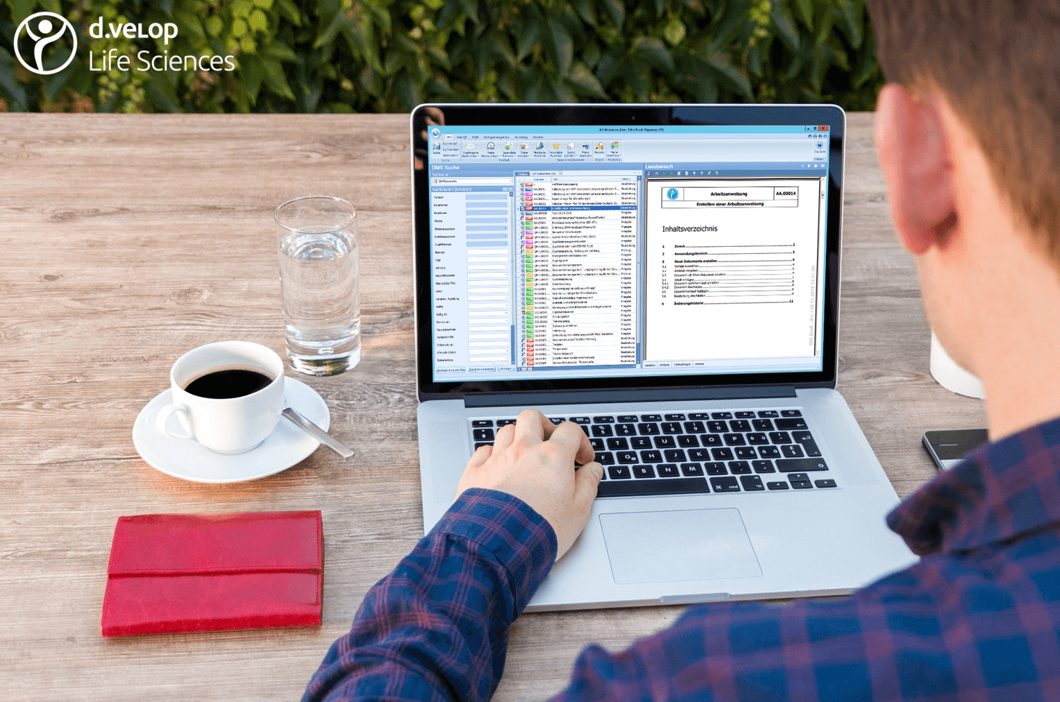 Representation of a man who accesses the document management system of Digital Life Sciences with a notebook while outdoors