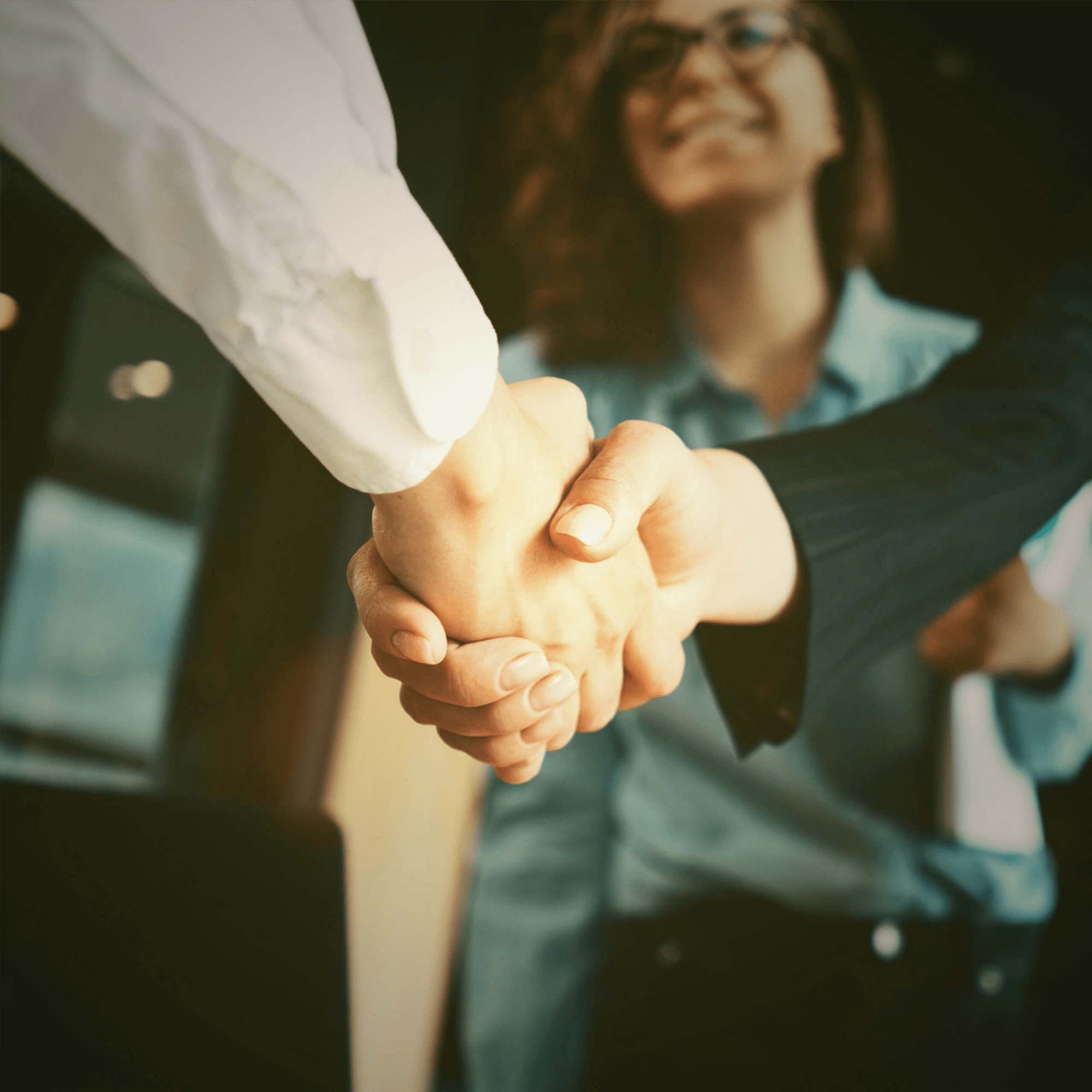 Successful partners (businessmen) shaking hands in the office.