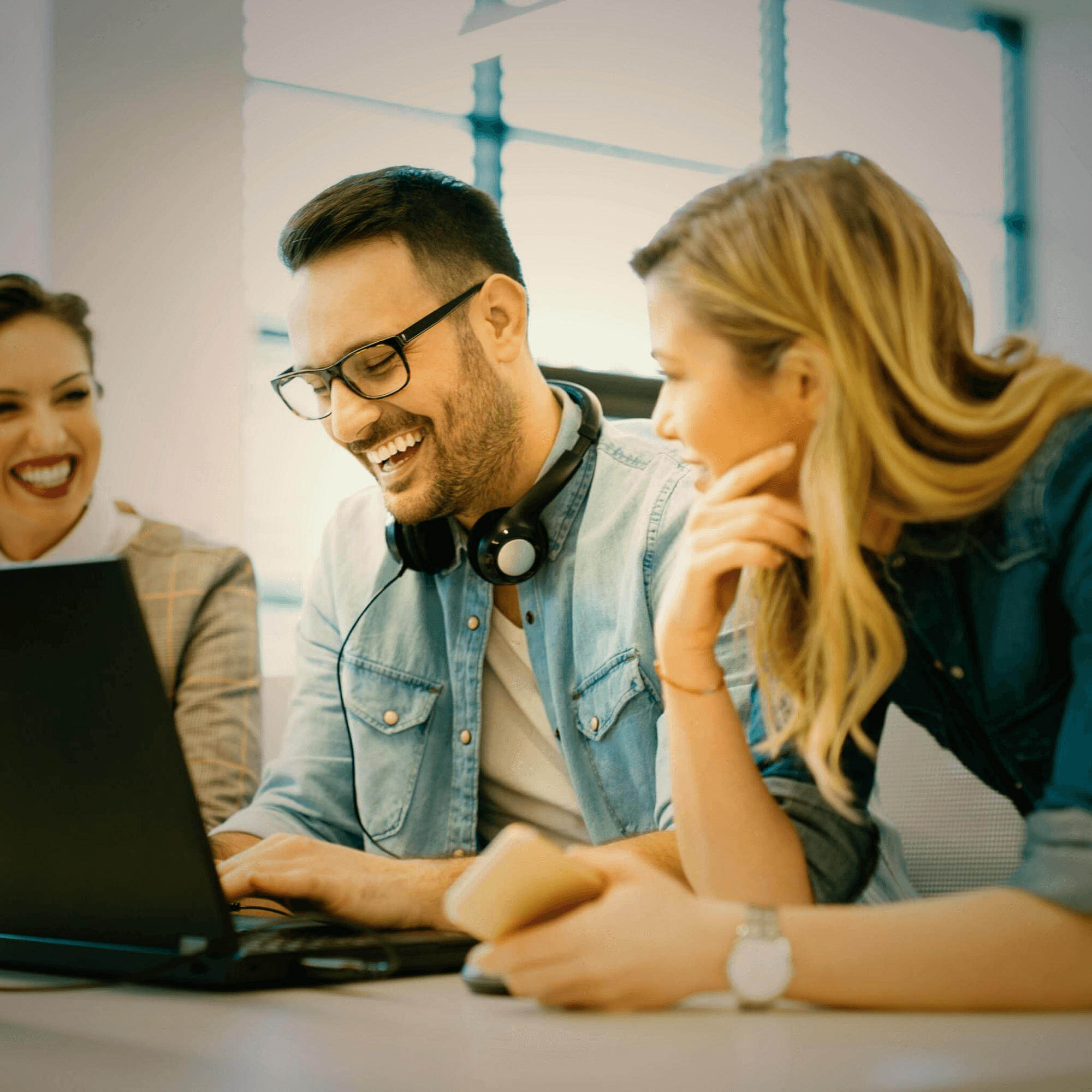 enthusiastic colleagues in the office celebrate their success