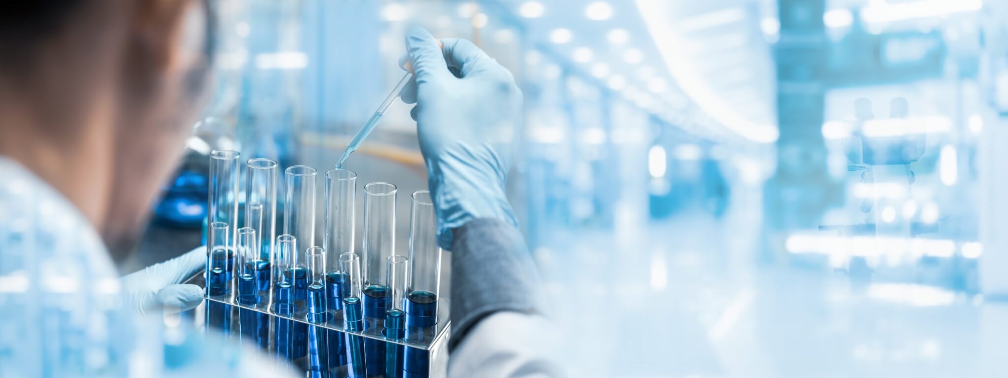 Man sitting in front of test tubes